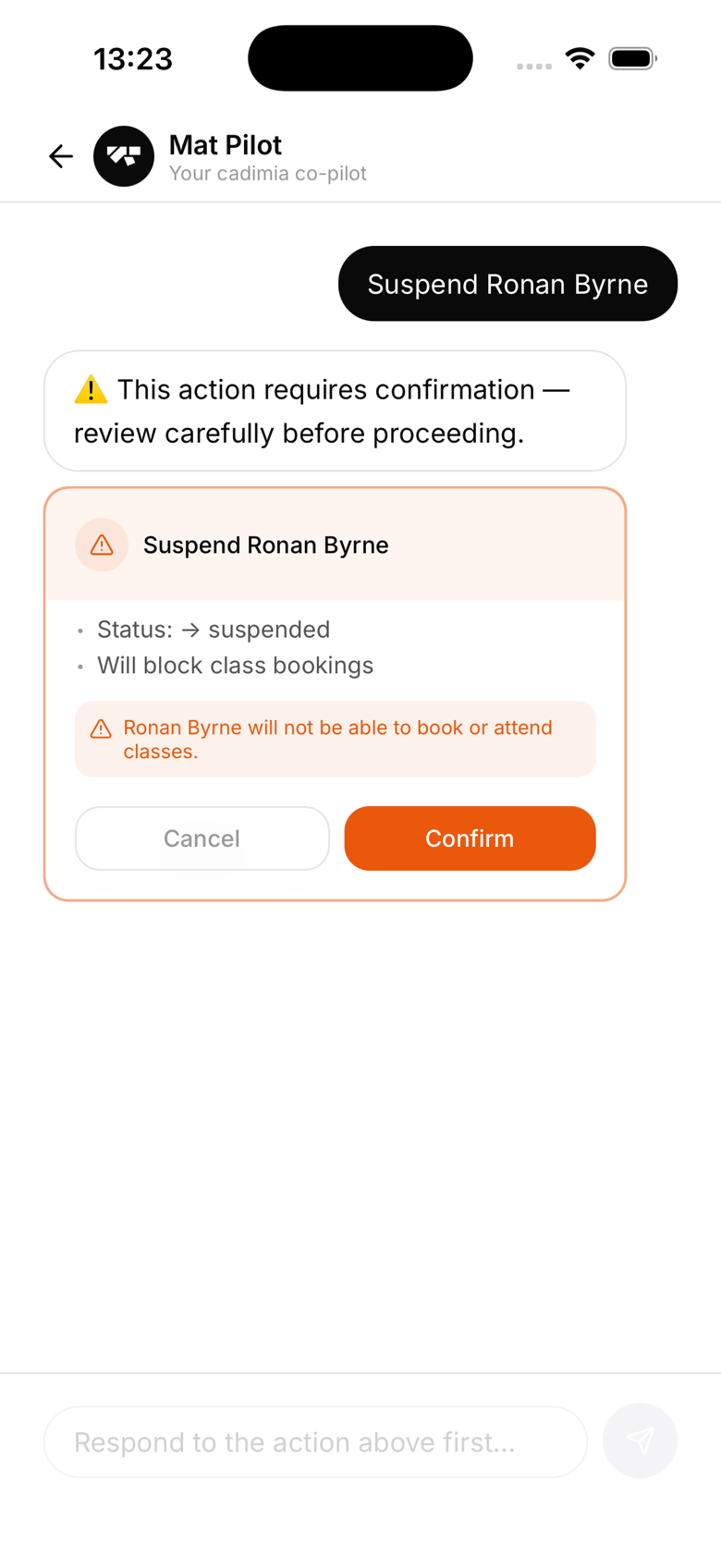 AI chat showing the orange suspend-member warning card with Confirm and Cancel buttons